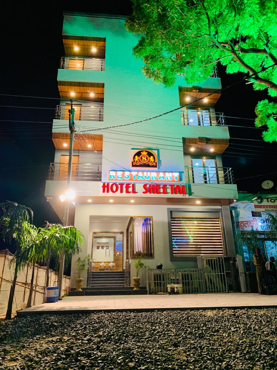 Hotel Sheetal lit up at night on Kaylana Circle